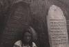 A Ukrainian(?) woman posing at the cemetery

(right: Yehuda Lev Hacohen ... He died 25th Adar I 5651. May his soul be bound in the bond of everlasting life)